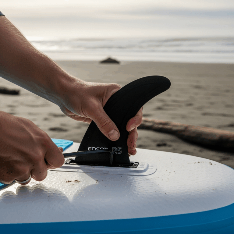 close up hands tightening inflatable paddle board fin into f 20260303 071257